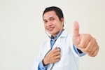 Male doctor giving a thumbs up