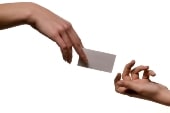 hand giving over small card
