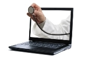 Doctors hand holding a stethoscope through a laptop screen