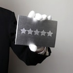hand holding up 5 star plaque