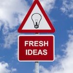Caution sign with a lightbulb on it with "Fresh ideas" text underneath