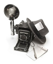 Publicity camera with notepad, pen, and news reporter fedora