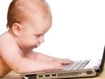 baby typing on laptop