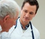 Male doctor looking at older male patient with a concerned expression