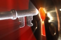 Key being inserted into glowing keyhole