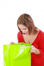 surprised woman looking in gift bag