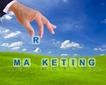 Hand placing an "R" letter in a marketing crossword against green grass & blue skies background