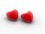 Two red heart-shaped beads against white background