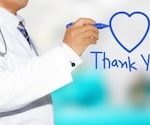 doctor writing thank you with a blue heart in blue ink