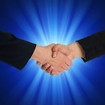 Handshake against blue light background