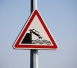 Car going into water warning street sign