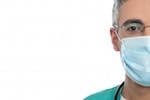 Aligned right image of half of surgeon's face wearing surgical mask
