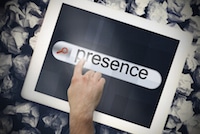 Person touching iPad displaying "Presence" text on screen