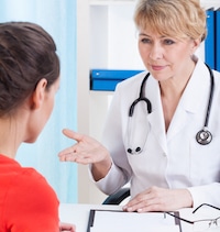 Young female patient communicating with older female doctor