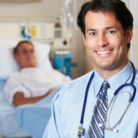 successful doctor smiling in patient room
