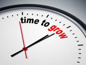 clock pointing to text reading "time to grow"