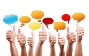 A line of hands giving thumbs up with colorful speech bubbles above them