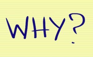 notepad paper with text reading "WHY?"