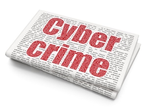 newspaper with red text reading "Cyber Crime"