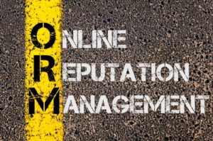 "online reputation management" in yellow text on cement road