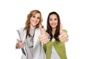doctor and patient holding thumbs up