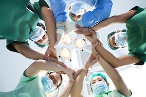 doctors in huddle over patient view point