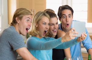 family looking at iPad type device