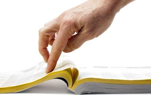 Person pointing at the yellow pages
