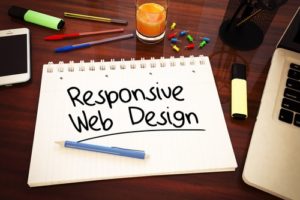 "responsive web design" drawn on sketchpad, sitting on desk