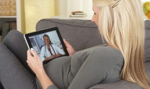 pregnant woman video chatting with doctor