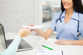 doctor giving patient sheet of paper