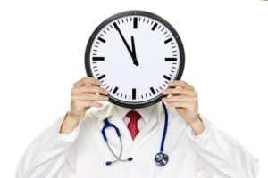 doctor holding up a clock
