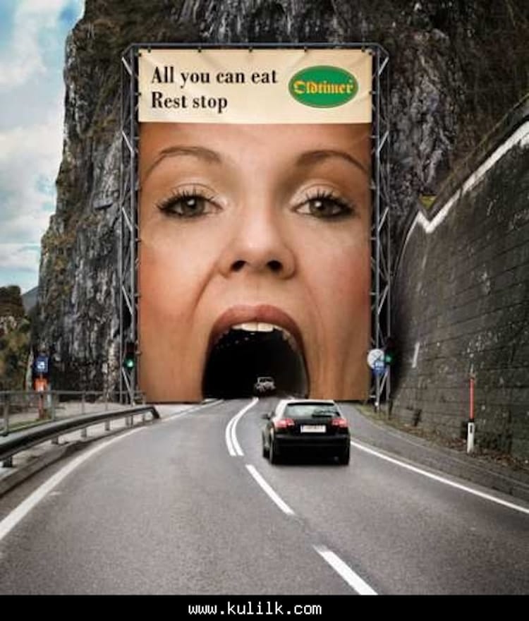 animated woman's open mouth as rest stop ad on mountain tunnel entrance