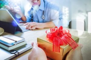 patient giving doctor a gift box