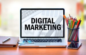 laptop displaying text reading "Digital Marketing"