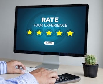 Person looking at a computer desktop displaying "Rate your experience" screen