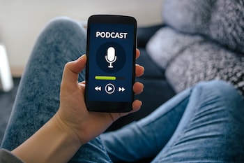 Person holding a phone, listening to a podcast