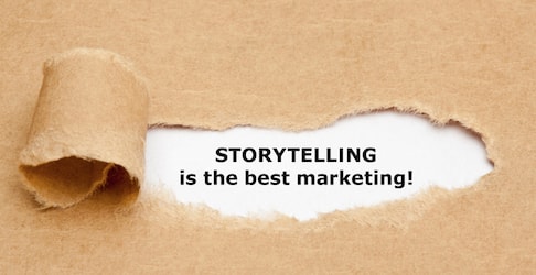 "storytelling is best marketing!" text uncovered under ripped cardboard