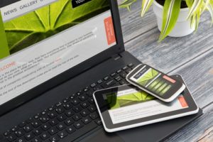 website design on computer and mobile devices on desk