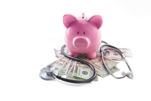 photo of piggy bank and spilled cash with stethoscope symbolizing private equity healthcare