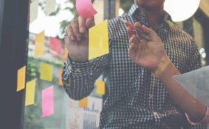 people using post-it notes to build top digital marketing agency strategy secrets