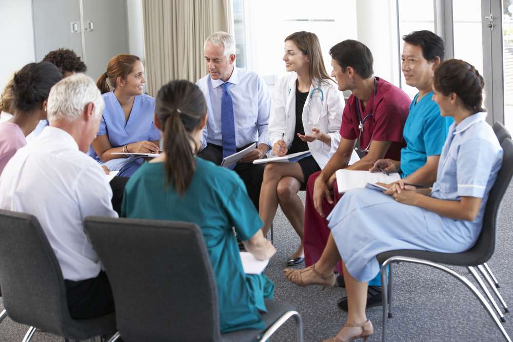 A group of medical professionals sitting in a circle for training