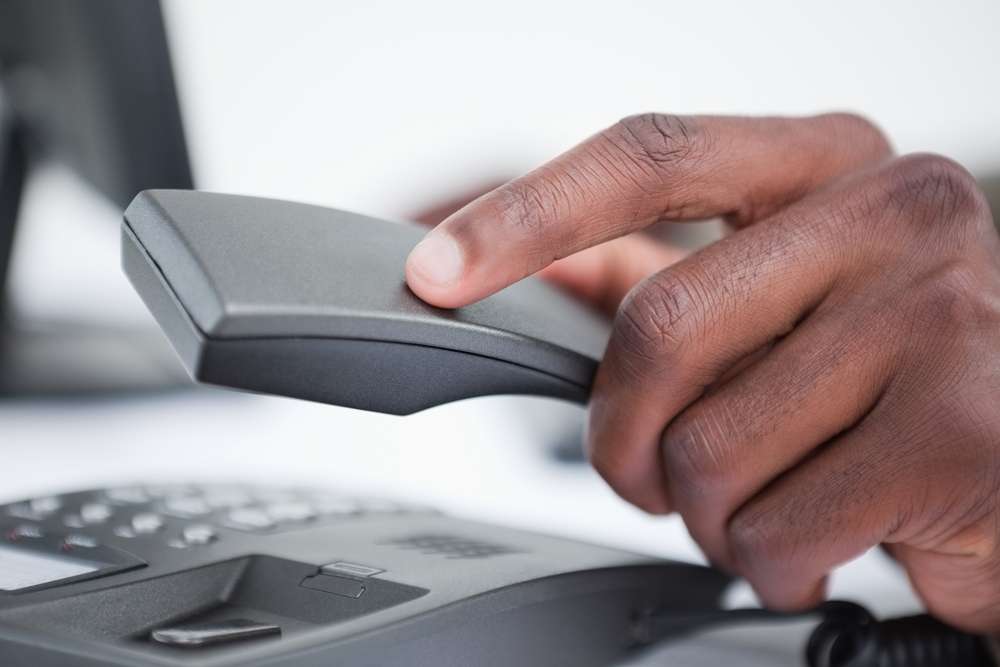Person holding an office telephone