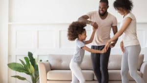 family dancing in living room