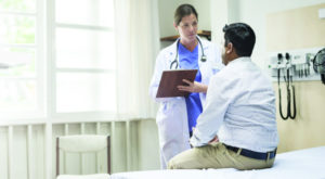 man speaking with physician