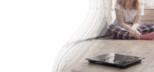 Teenage girl looking at scale